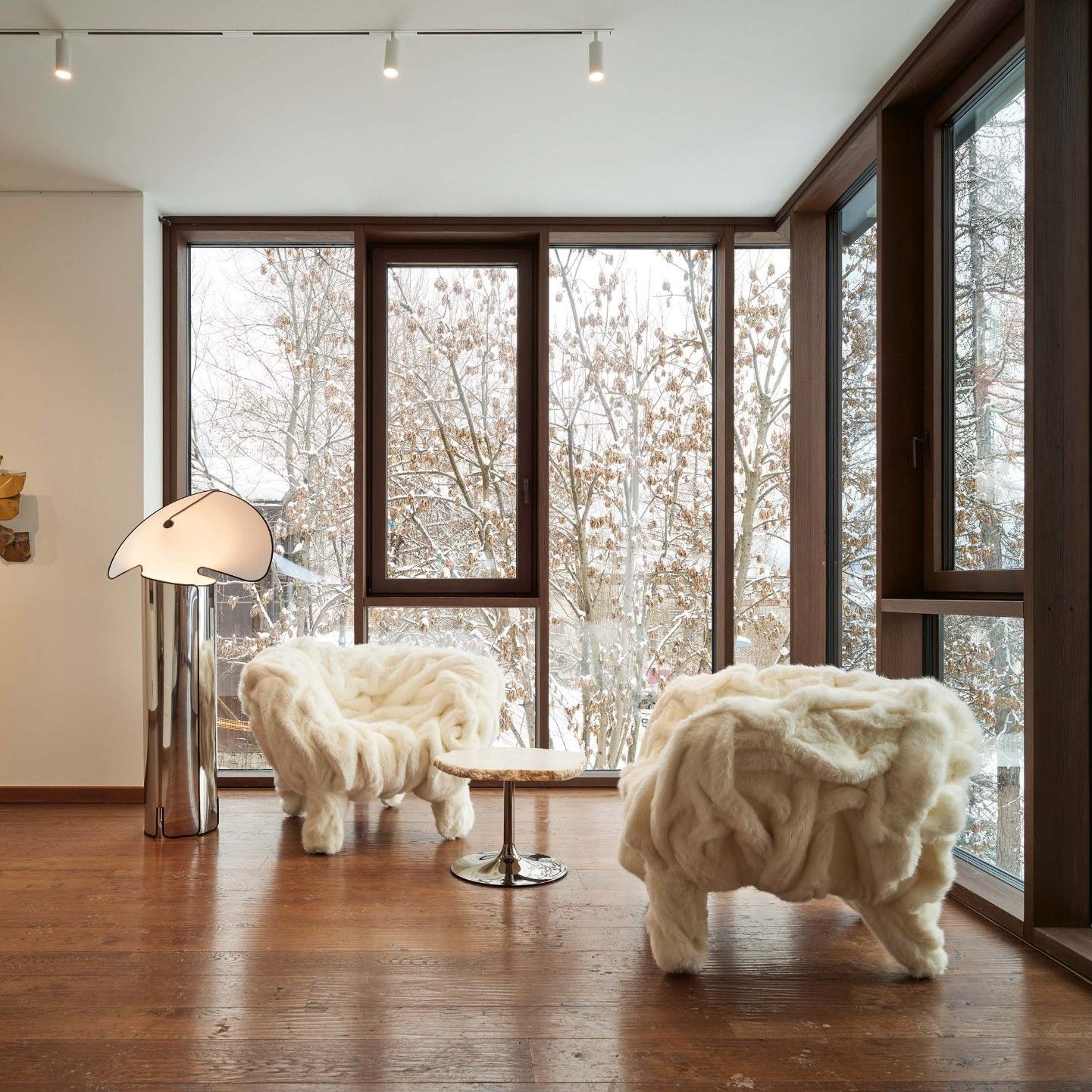  Grinza White, Cicladi. Eco Fur armchairs and natural alabaster tables bring the hushed sensation of snowy landscapes to Casa Italia in Cortina d&rsquo;Ampezzo. 